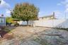 Fenced backyard with a patio and area for grilling