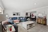Living room with ornamental molding, light wood-style flooring, and recessed lighting
