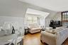 Living room featuring lofted ceiling and wood finished floors