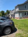 View of home's exterior featuring a shingled roof and a lawn