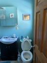Bathroom with toilet, vanity, and tile patterned flooring