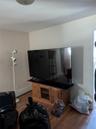 Living room with a baseboard heating unit and hardwood / wood-style floors