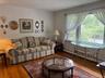 Living area with baseboard heating and wood finished floors