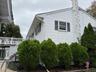 View of home's exterior featuring stairs, a wooden deck, and a chimney
