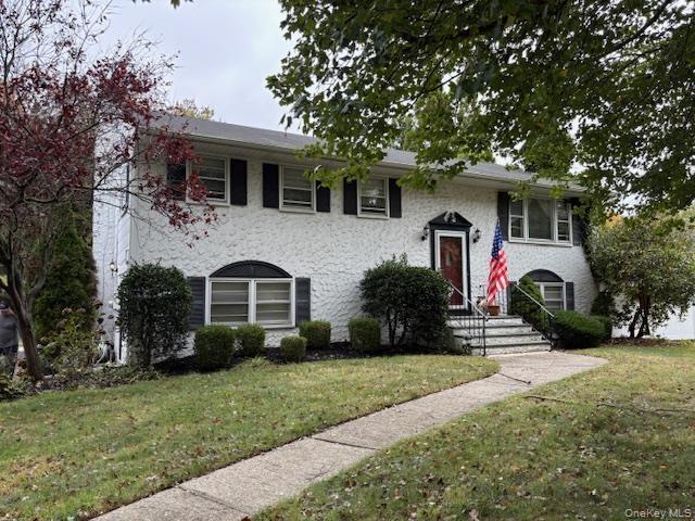 View of front of property with a front lawn