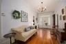 Entryway with hardwood / wood-style floors, crown molding, and a chandelier