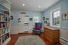 Sitting room with wainscoting, a baseboard heating unit, dark wood finished floors, and recessed lighting