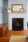 Detailed view of wood finished floors and a fireplace with flush hearth