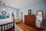 Bedroom featuring wood finished floors and baseboards