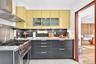 Kitchen featuring high end stainless steel range, wall chimney exhaust hood, modern cabinets.