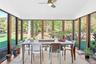 Sunroom / solarium featuring wood finished floors and vaulted ceiling