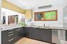 Kitchen featuring dishwasher, plenty of natural light, light tile patterned floors, and modern cabinets