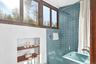 Bathroom with shower / bath combo and a sink