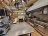 Kitchen with light tile patterned flooring, extractor fan, and open shelves