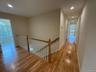 Hallway featuring an upstairs landing, recessed lighting, and light wood-style flooring