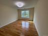 Spare room featuring light wood-style flooring and baseboards