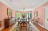 Spacious Dining Room with lovely moldings, herringbone floors and windows overlooking the property