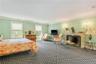 Gracious and spacious primary bedroom with fireplace
