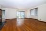living room with doors to water view balcony featuring healthy amount of natural light,  recessed lighting wood burning fireplace