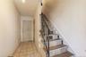Staircase with tile patterned floors and wood walls