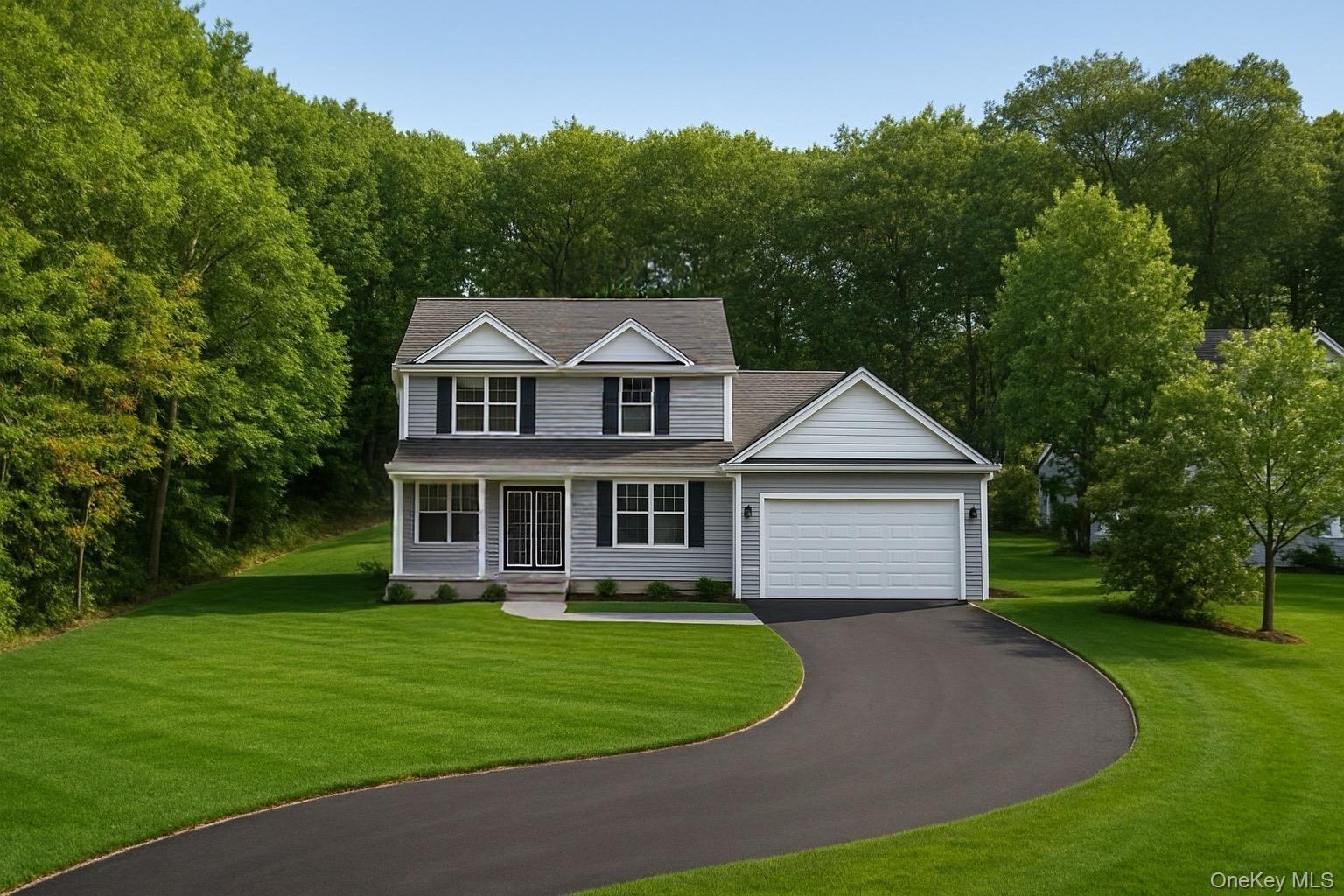 View of front facade featuring driveway, a front yard, a garage, and a porch