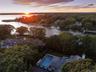 Bird's eye view of a heavily wooded area and a large body of water