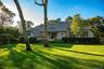 View of front of property with a front lawn and covered porch