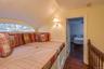 Bedroom featuring vaulted ceiling, dark wood finished floors, and a walk in closet