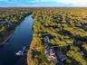 Aerial view of property and surrounding area featuring a large body of water and property parcel outlined