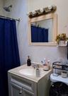 Full bath featuring vanity, curtained shower, and tile walls