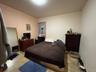 Bedroom with light tile patterned floors