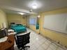 Bedroom featuring light tile patterned floors and beam ceiling in the landlords apartment.