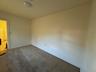 Unfurnished room with carpet