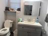Bathroom vanity and toilet in the commercial unit.