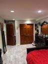 Bedroom with a closet, recessed lighting, and wood tiled floors