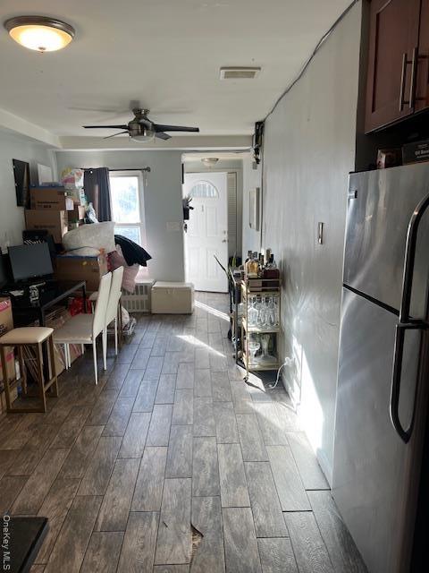 Dining room with ceiling fan and dark wood-type flooring