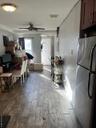 Dining room with ceiling fan and dark wood-type flooring