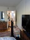 Bedroom with wood finished floors and ornamental molding