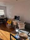 Home office with a textured wall, wood finished floors, and a textured ceiling