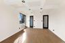 Empty room featuring coffered ceiling, beamed ceiling, light wood-style flooring, and a wall mounted air conditioner