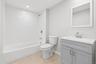 Bathroom featuring vanity, light tile patterned floors, bathtub / shower combination, and recessed lighting
