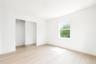 Unfurnished bedroom featuring light wood-style floors and a closet