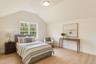 Bedroom with lofted ceiling and light wood-style flooring