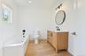 Full bathroom featuring a bath, light wood finished floors, vanity, and recessed lighting