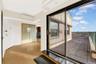Doorway to outside featuring a wall mounted AC and wood finished floors