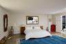 Bedroom with a baseboard radiator and ensuite bath