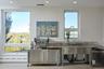 Kitchen featuring stainless steel counters, a baseboard heating unit, recessed lighting, and dishwasher