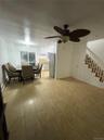 Dining space with stairs, ceiling fan, and a baseboard heating unit