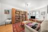 Living room with light wood finished floors and radiator heating unit