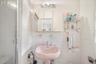 Bathroom featuring tile walls and tasteful backsplash
